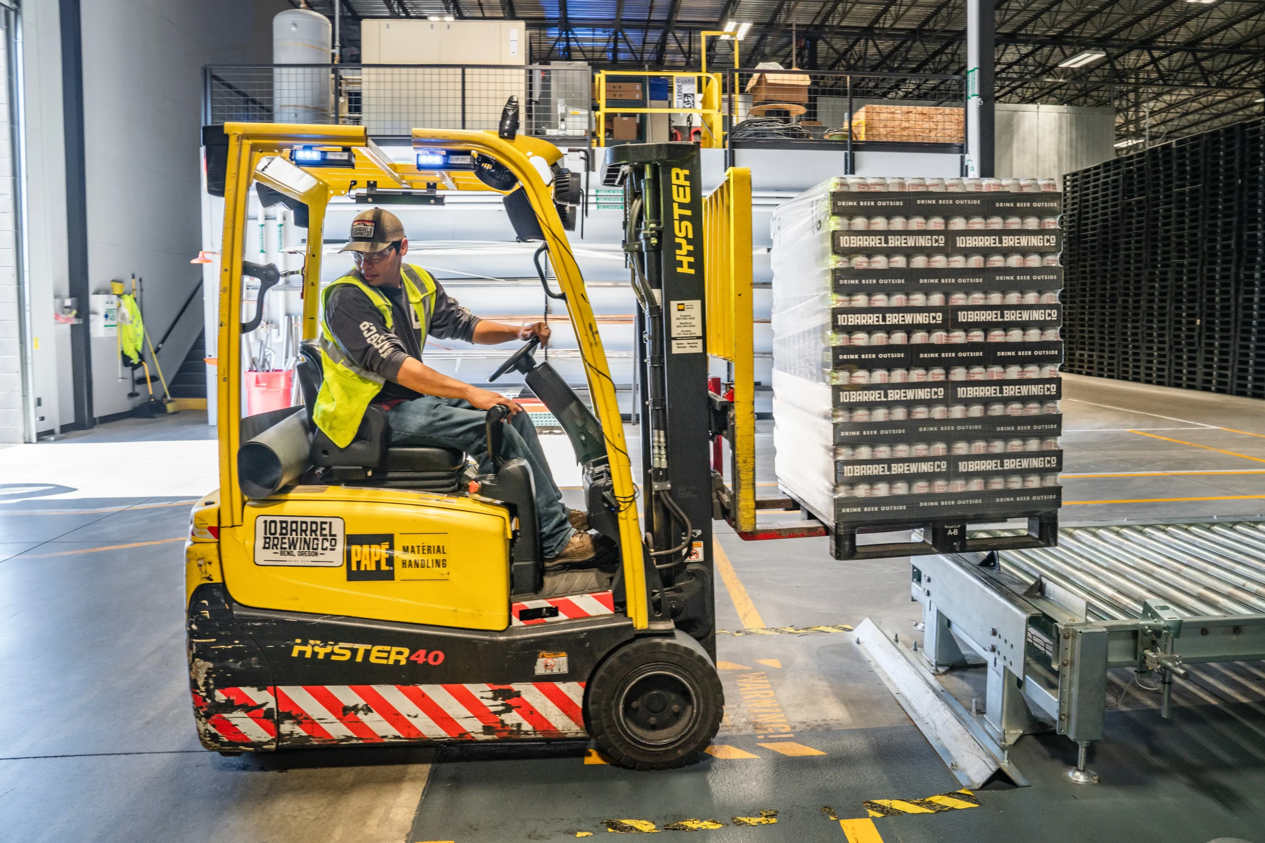 warehouse worker using forklift to move products